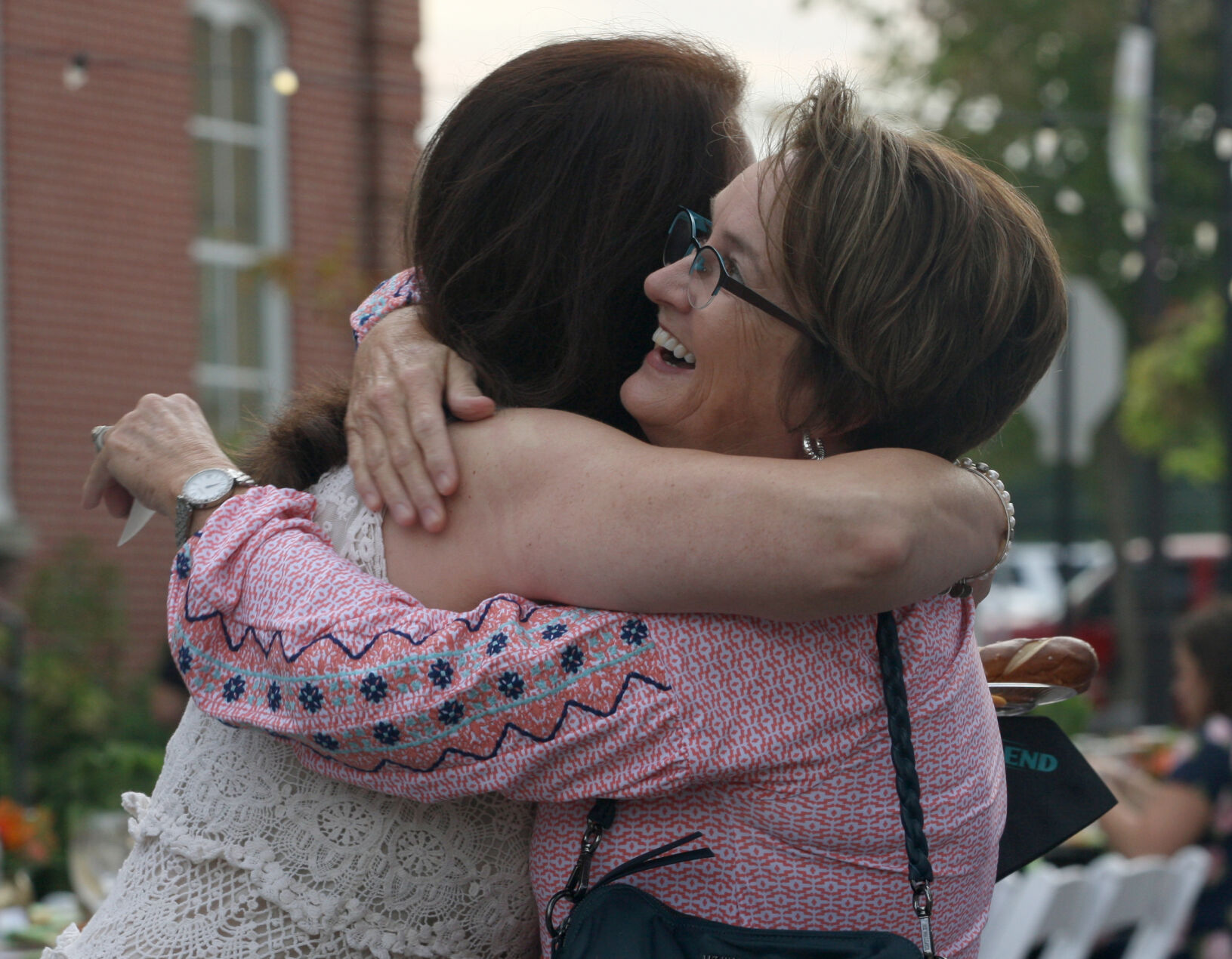 Gretchen Farrell hugs Cindy DuMontier